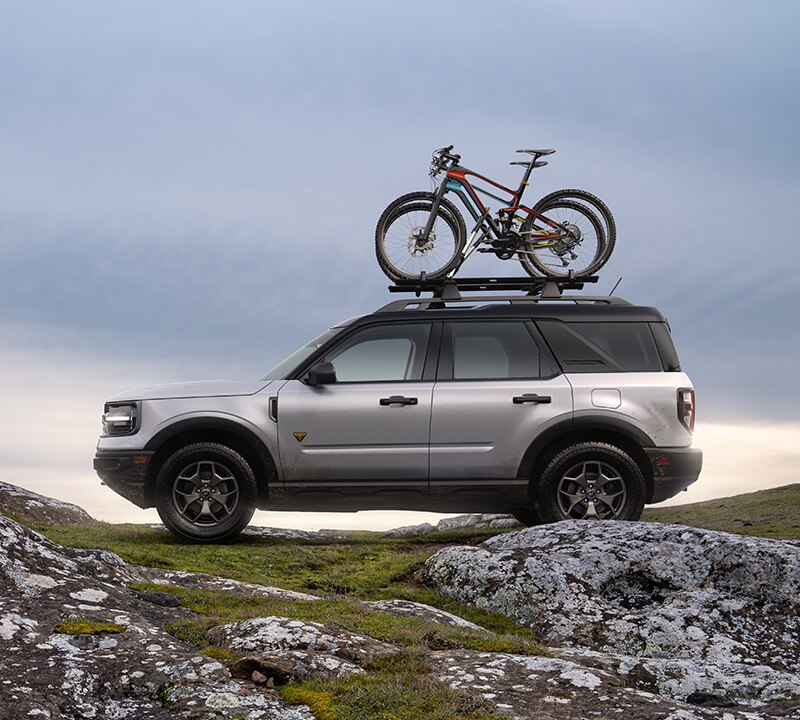 Ford Bronco with a roof-mounted bike rack and bikes.
