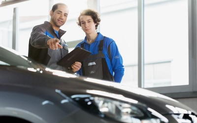 A Ford Service Technician installs a tire on a vehicle.