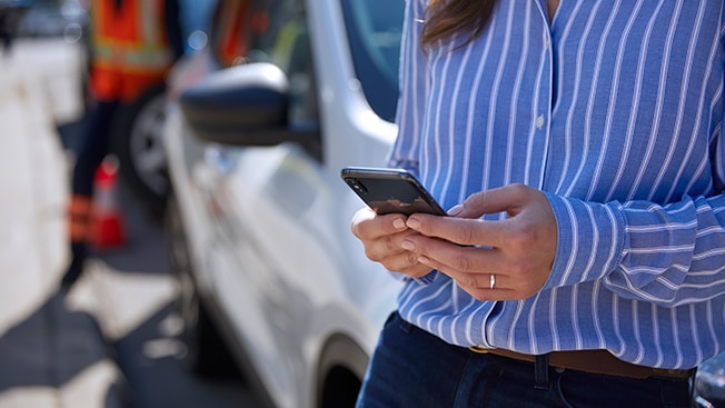 Close-up of a woman searching for information on her phone.