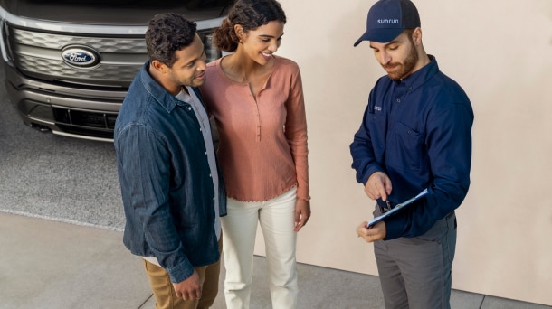 Service technician conversing with couple.
