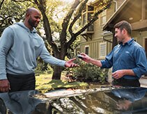 Driver handing key to customer