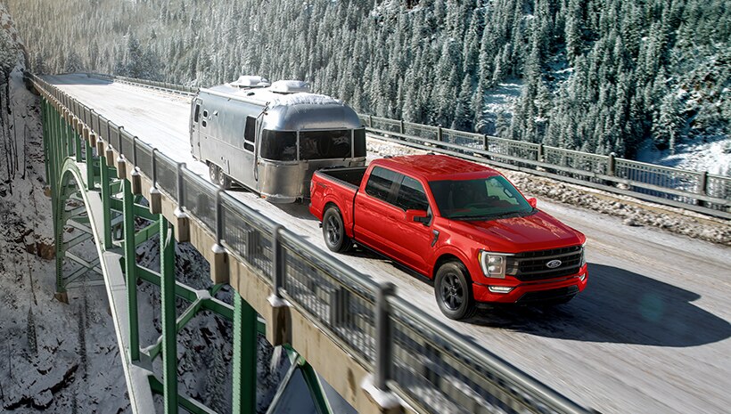 Vehicle towing camper on a bridge