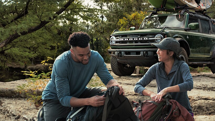 Couple outdoors with vehicle