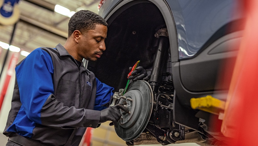 Technician working in brakes.