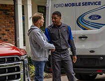 Customer and technician with vehicle and Ford Mobile Service van