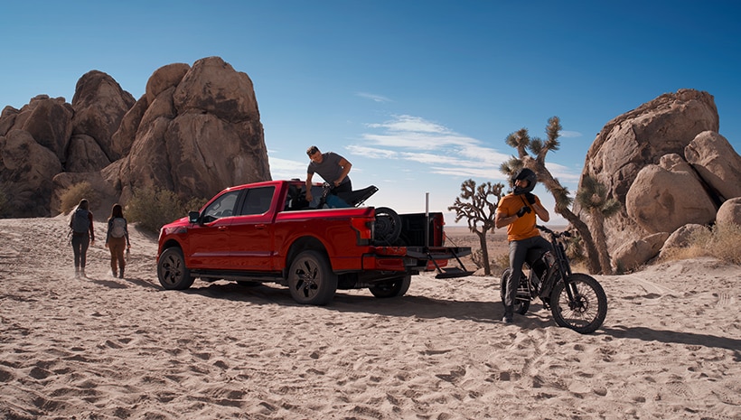 Truck and people in desert landscape