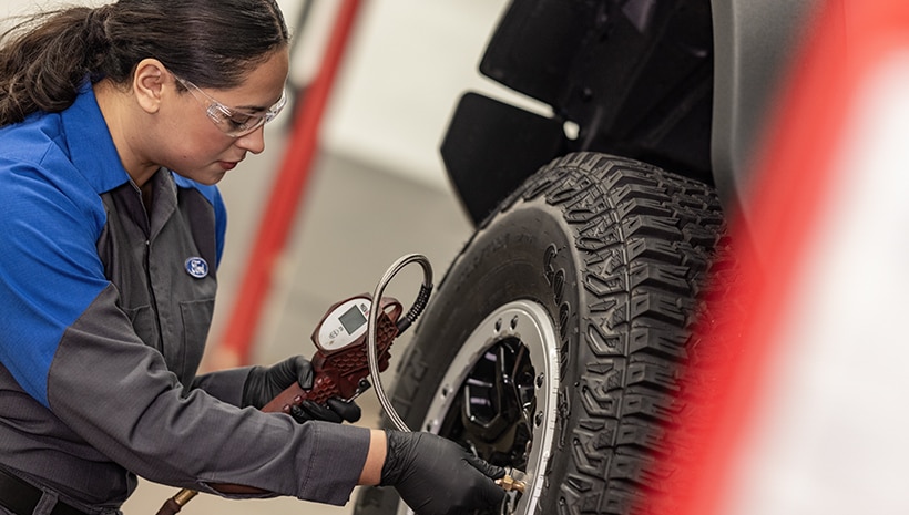 Technician working on tires in a service bay
