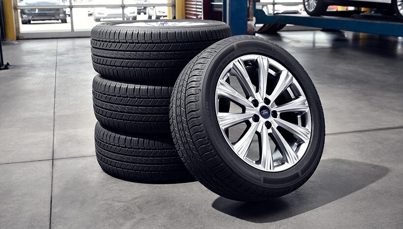 A stack of 4 tires on service bay floor