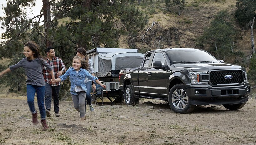 Family with truck and trailer camper