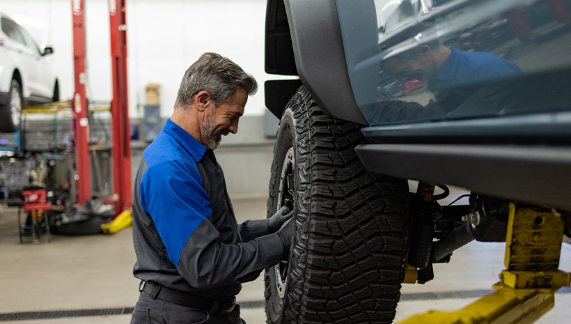 Technician working on tires.