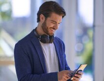 Person smiling and looking at their phone