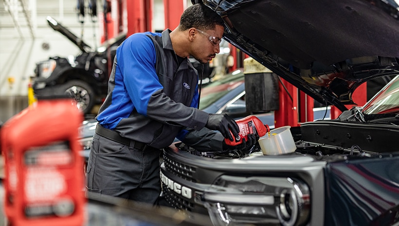 Service technician changing a vehicle’s oil