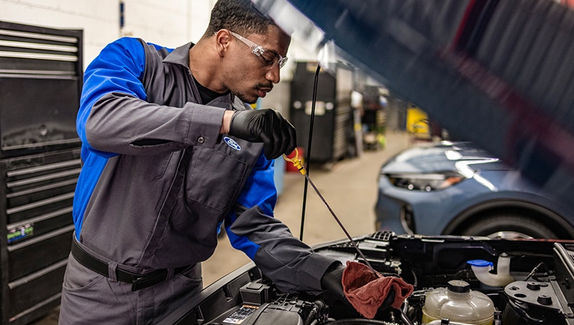 Service technician changing a vehicle’s oil