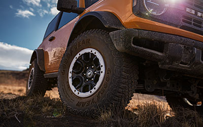 Close up of Ford Bronco sport tire rolling through the mud