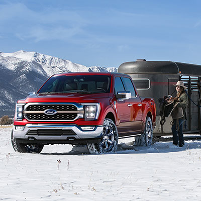 Woman standing next to an F 1 50 with a horse trailer
