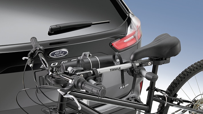 The Ford Edge® SUV carries a mountain bike on a bike rack accessory.