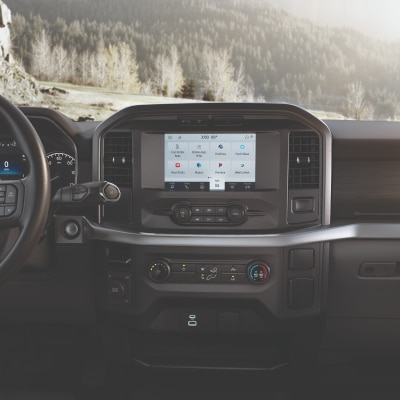 The center console of a parked 2023 Ford F-150® truck showing the SYNC® 4 Technology touchscreen.