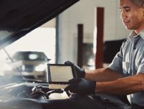 A Lincoln® service technician is shown inspecting an air filter
