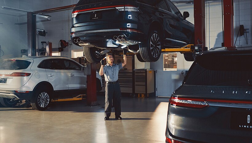 Technician working on vehicle
