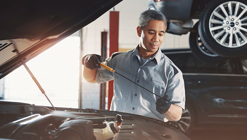 Lincoln technician with vehicle in service bay