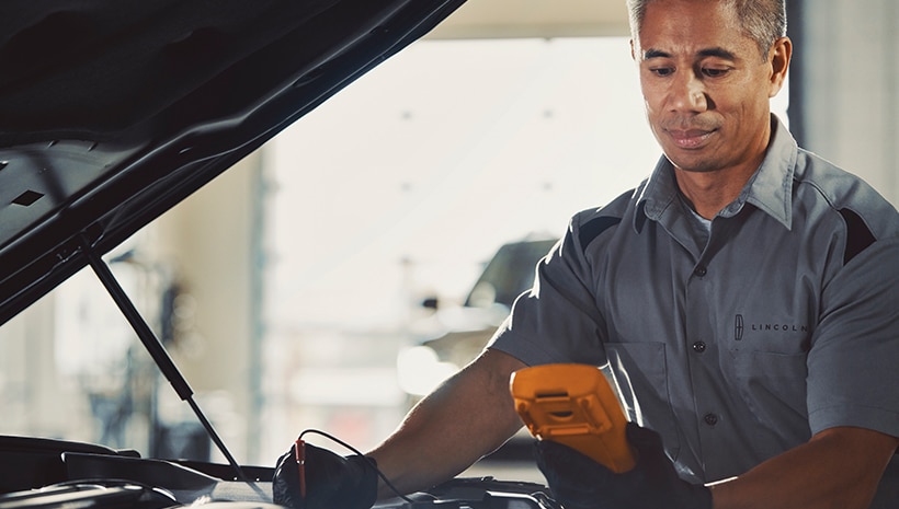 Lincoln technician with vehicle in service bay