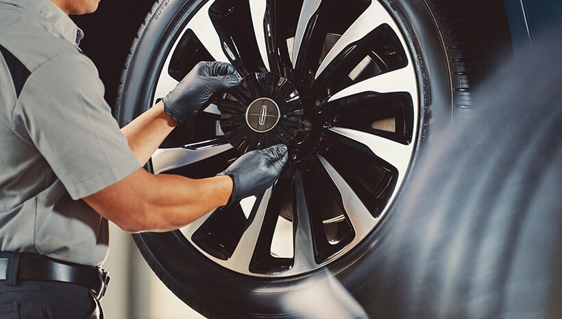 Service Technician with a tire