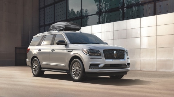 A cargo carrier is shown mounted on top of a Lincoln® Navigator