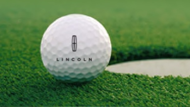 A golf ball is shown with the Lincoln® star logo on it