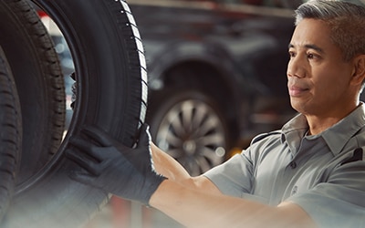 Technician examines tire