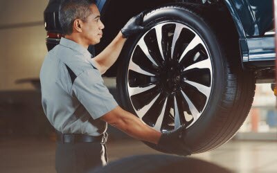Service Technician with a tire