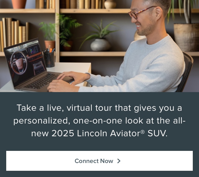 A person watches a Lincoln Aviator SUV virtual tour on a laptop.