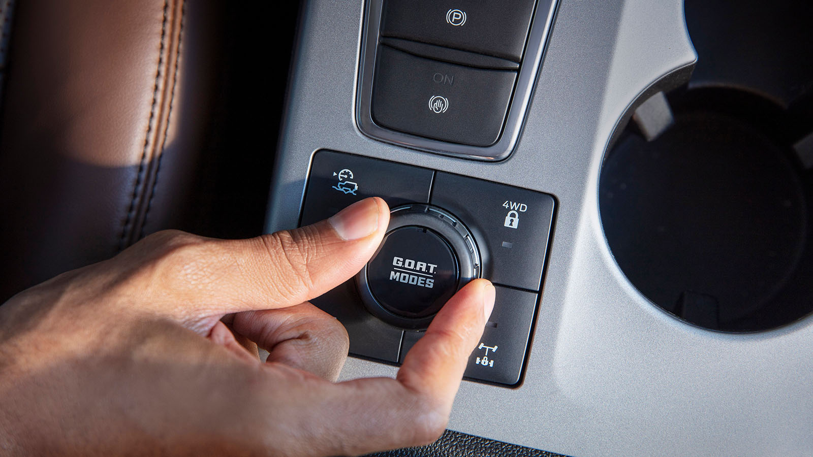 Close-up of a hand turning the G.O.A.T. Modes® Goes Over Any Type of Terrain knob in a 2023 Ford Bronco® Sport SUV.