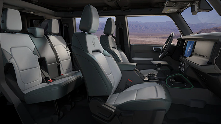 Interior view of a 2023 Ford Bronco® SUV driver and front passenger seats, steering wheel, dashboard, and center touchscreen.