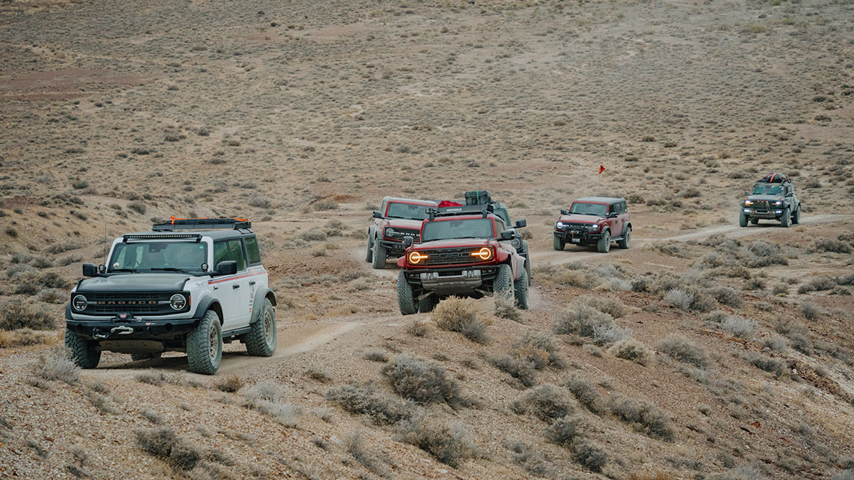 A pack of off-roaders overland a remote trail in their Bronco® SUVs.