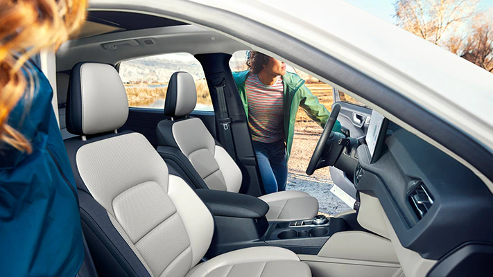 A driver and passenger step into the Escape® SUV.