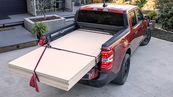 The bed of the Maverick® pickup loaded up with plywood.