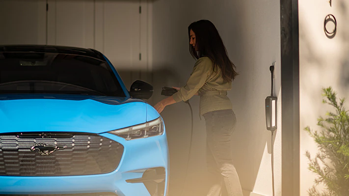 An owner plugs in their Mach-E® SUV at home.