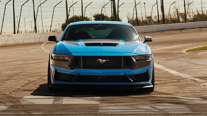 A Mustang® coupe opens up on a track straightaway.