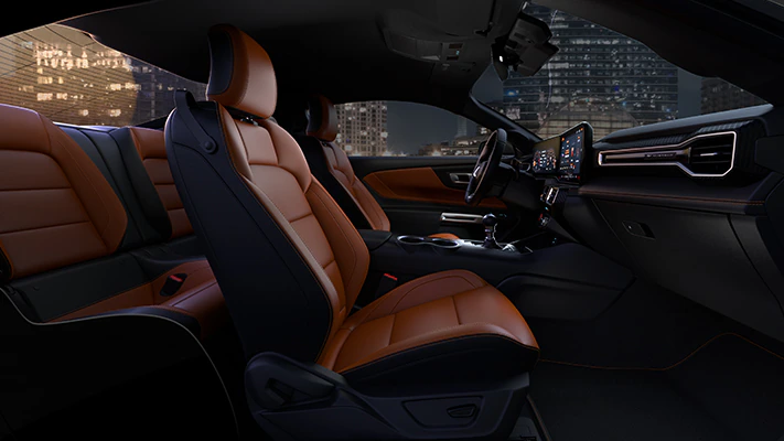 The performance interior of the Mustang® coupe illuminated by the ambient light of the city at night. 