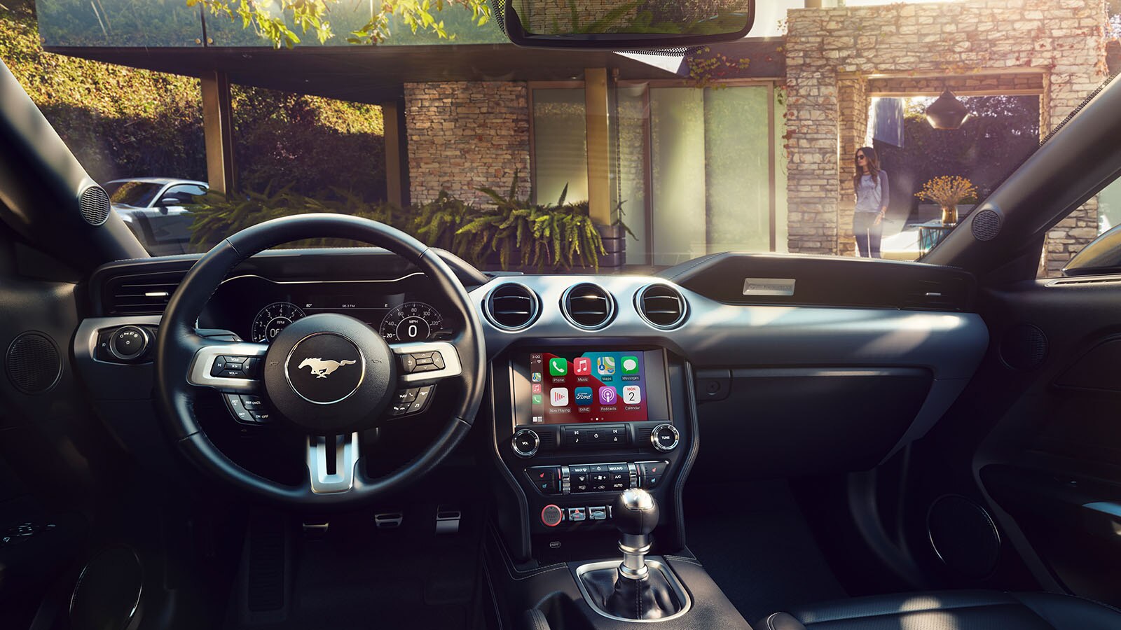 The inside of a 2023 Ford Mustang® vehicle steering wheel, instruments, and center console with optional equipment shown. 