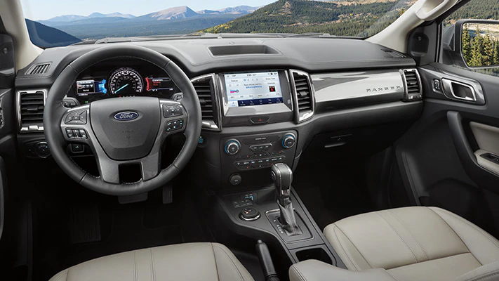 Interior of a 2023 Ford Ranger® LARIAT® truck featuring the center console and in-vehicle touchscreen.
